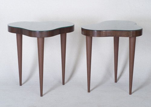 GILBERT ROHDE Pair of fine HERMAN MILLER: GILBERT ROHDE Pair of fine HERMAN MILLER Paldao lamp tables, each with glass-covered cloud-shaped top on three tapering legs with tacked-on brown leatherette. Foil label, "Herman Miller/Gilbert Rohde