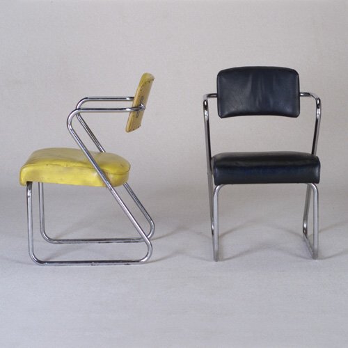 GILBERT ROHDE: Five TROY SUNSHADE CO. tubular chrome armchairs, each with either yellow, dark green, dark blue, red or black upholstery. (Two shown). Troy Sunshade decals. 32" x 20" x 22"
