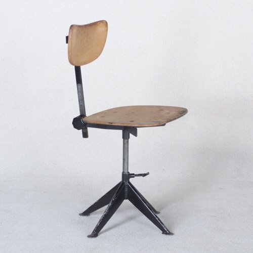 KNOLL: Drafting stool with molded plywood seat and back on black metal frame. Missing upholstery. Unmarked. 33 1/2" x 16 1/2" x 19 3/4"