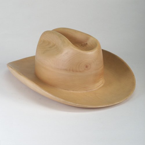 DKNY: Carved maple maquette of a fedora designed for DKNY. Ink signature on interior. 6" x 14 1/2"