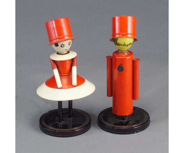 Pair of CHASE "Colonel" and "Colonel's L: Pair of CHASE "Colonel" and "Colonel's Lady" accent lamps designed by LURELLE GUILD, each with red, white, and black enameled details, frosted glass light bulb "faces" with painted details, and tiltin