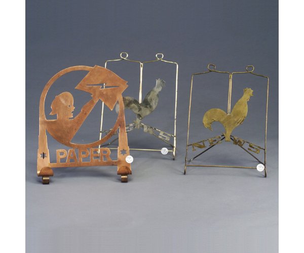 Three CHASE newspaper holders: one in co: Three CHASE newspaper holders: one in copper with newspaper vendor, and one each in brass and chrome designed by LURELLE GUILD, with rooster. Some finish wear. Latter two marked, also with pat. nos. 1