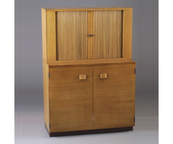 GILBERT RHODE china cabinet with two tam: GILBERT RHODE china cabinet with two tamboured doors to top, black lacquered interior and single shelf, the two-door base stores a free-standing black lacquered gate-leg dining table. 52" x 36" x 17"