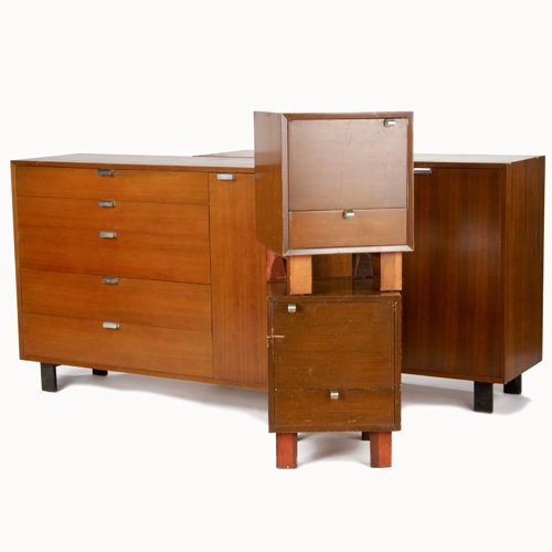 GEORGE NELSON/HERMAN MILLER Four walnut veneer ca: GEORGE NELSON/HERMAN MILLER Four walnut veneer case pieces: a pair of five-drawer chests with single cabinet door, and a pair of nighstands with lower drawer, all with chrome pulls. All with Herman Mi