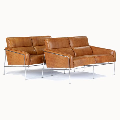 ARNE JACOBSEN Pair of brown leather settees on tu: ARNE JACOBSEN Pair of brown leather settees on tubular chrome frames. 28 1/2" x 49" x 28"