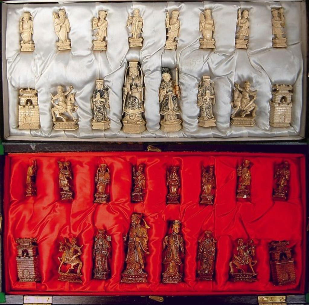 Chinese carved ivory chess set: FINE Chinese 32 piece carved ivory chess set in original silk hand-made fitted box, the figures ranging from 2.1"-4" tall, a few have minor losses from age and use, the chessboard topped box measuring