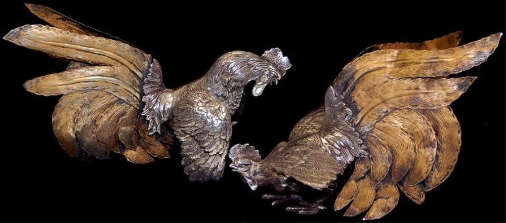 Pair of sterling silver fighting roosters: Pair of sterling silver fighting roosters having cast bodies with bronzed silver feathers measuring 11" x 7" each, weighing 2,033.6 grams