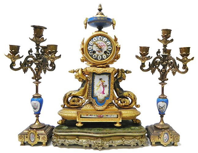 French 3 piece Louis XVI style mantle clock: P. H. Mourey French 3 piece Louis XVI style mantle clock and candle garniture set, gilt bronze casing with hand painted porcelain urns and dial the outer figures of two boys holding down the clock, th