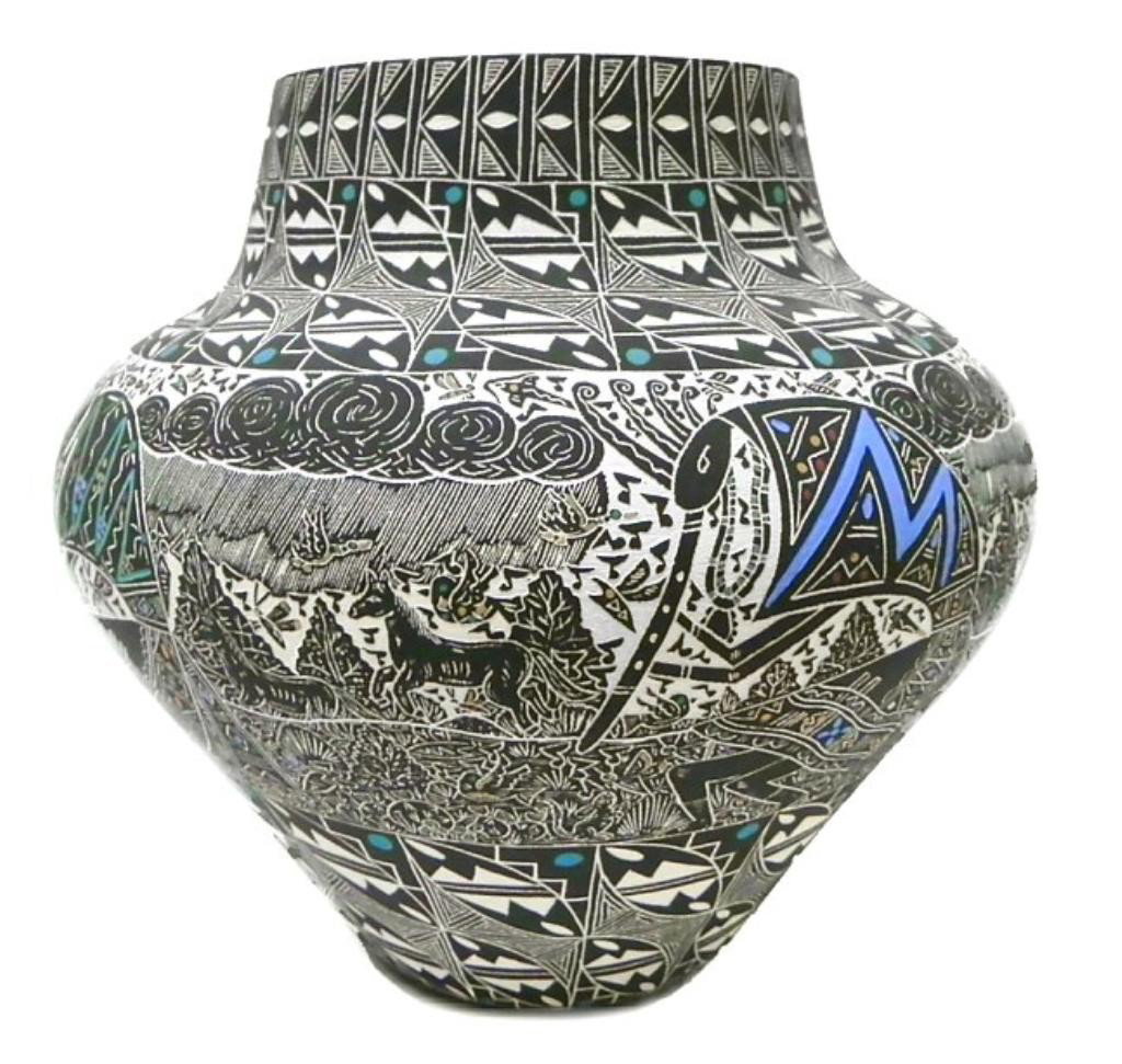 Nathaniel Vallo hand etched Kokopelli pottery: Nathaniel Vallo hand etched Kokopelli pottery depicting Kokopelli dancers, storms, pueblos and butterflys in black and white with shades of blues, greens and yellow, excellent condition, measuring 9" 