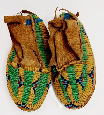 FINE pair of 19th cen. Comanche child's moccasins: FINE pair of 19th cen. Comanche beaded buckskin child's moccasins measuring 4" x 2" c.1880-1910
