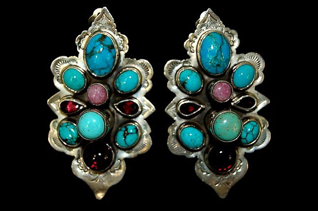 Navajo sterling gemstone earrings: Navajo sterling gemstone clip-back earrings set with 20 turquoise, sugilite and garnet gemstones, measuring 2.5" x 1.4", artist signed with "R" over "X"