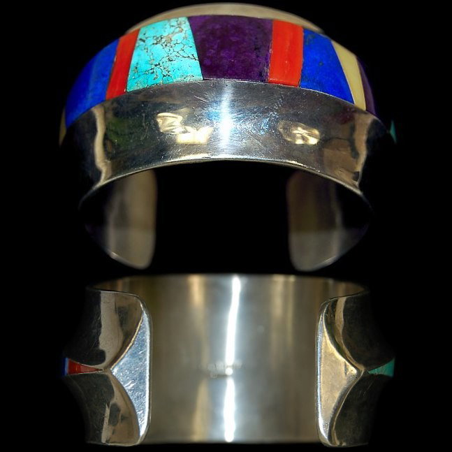 F. Carillo inlaid lady's cuff: F. C. Carillo inlaid lady's cuff with 13 gemstones to include turquoise, lapis, mother of pearl, coral and sugilite in a tapered cuff measuring 1.56" wide, artist signed