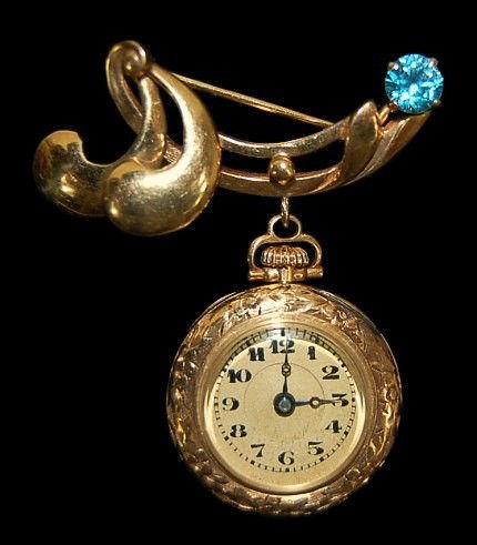 14K blue spinel lavalier lapel watch: 14K lavalier lapel watch having a 15 jewel Ariston movement in a 23.8mm 14K case, prong set with a natural blue spinel gemstone, running and keeping time