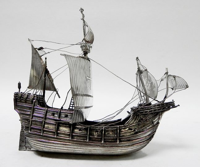 Sterling reproduction of Columbus' ship: A sterling (tested) silver reproduction of one of the Christopher Columbus expedition ships, made from sheet sterling, measuring approx. 8" length, overall good condition, some rigging needing reposit