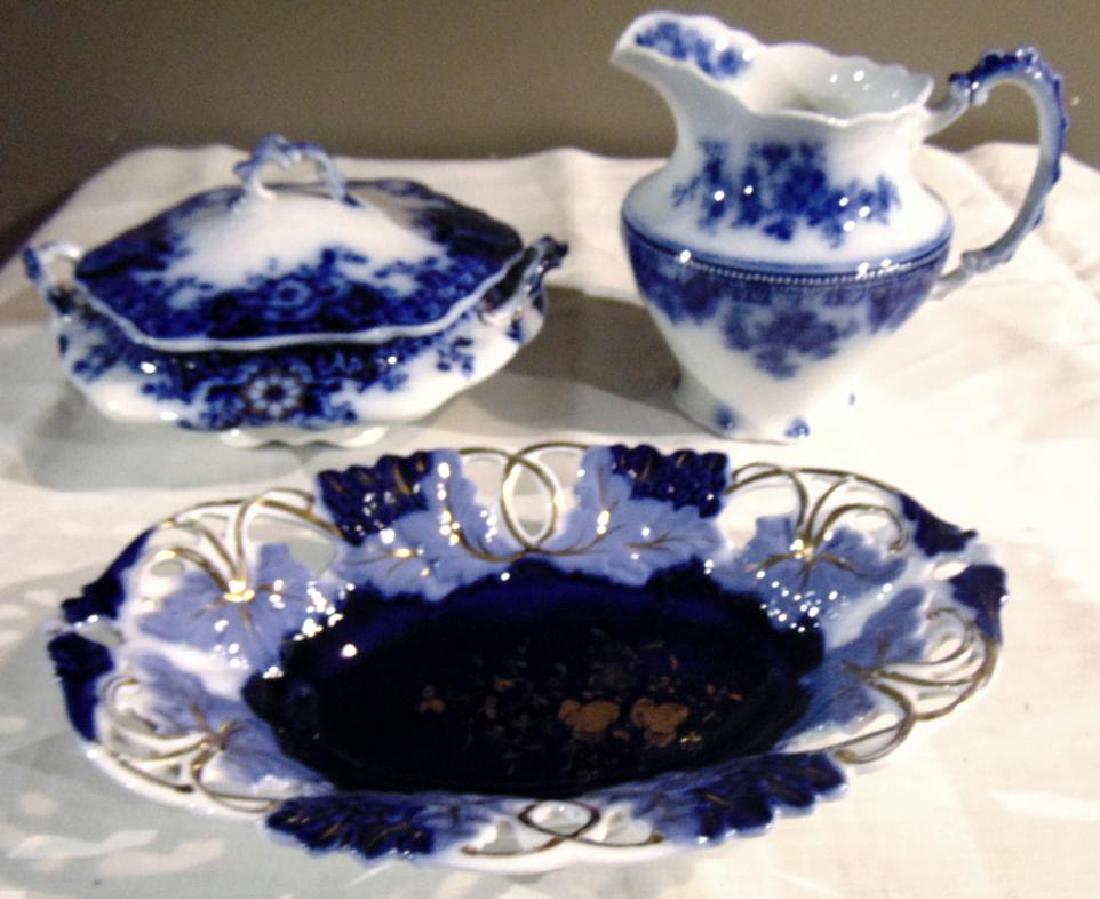 Flow Blue Brooklin Royal Porcelain Tureen +: Flow Blue group to include: Brooklin Royal Porcelain England covered and handled tureen (4.5"h x 9.5" x 9"); pitcher, marked on bottom (7"h x 7.5" x 4"); oblong pierced bowl, Made in Germany (2"h x 12