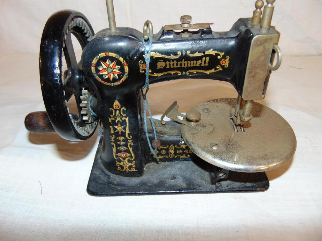 Stitchmell sewing machine, childs iron: Stitchmell sewing machine, child's iron, working with good decorations. 9" long, 6-1/2" tall