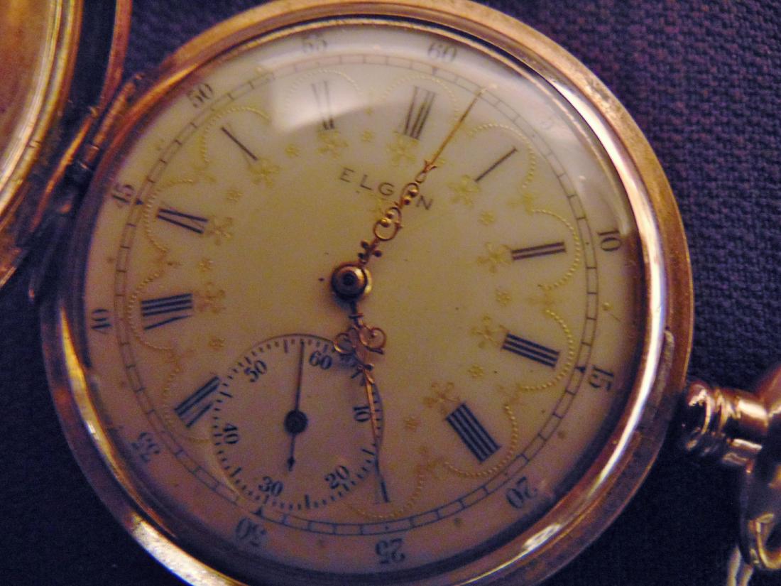 Elgin Heavy Rolled Gold Pocket Watch & Fob Chain: Elgin heavy rolled gold pocket watch, fancy enameled scrolled face, elaborately chased case, 18 jewels, registration #8096010, appears to be running; along with watch fob chain with locket (2").