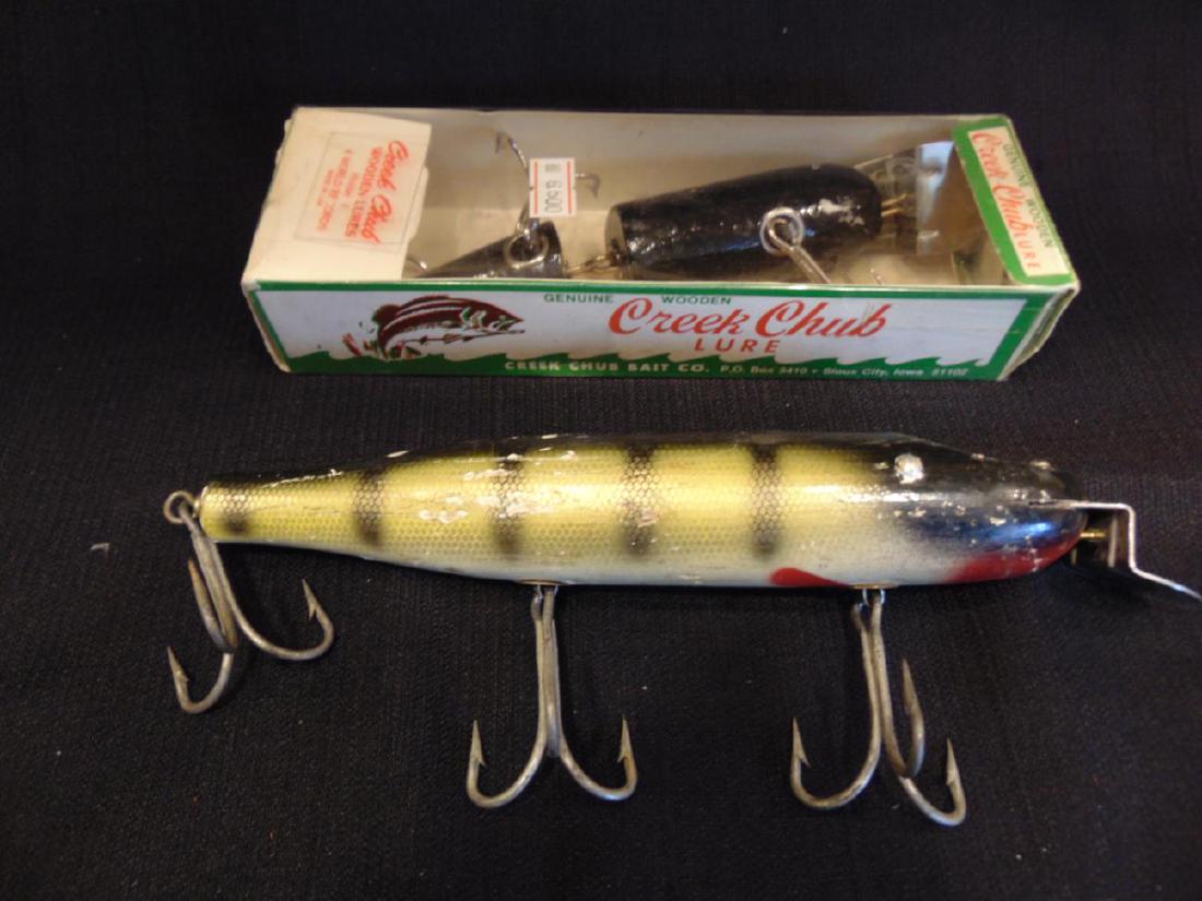 Creek Chub & 1 Other Fishing Lure: Creek Chub fishing lure by Creek Chub Bait Co., Sioux City, IA, No. 6800W, from the 1950's, in original package (8.5" x 2" in box; Along with another wooden musky bait, losses to paint noted (6").