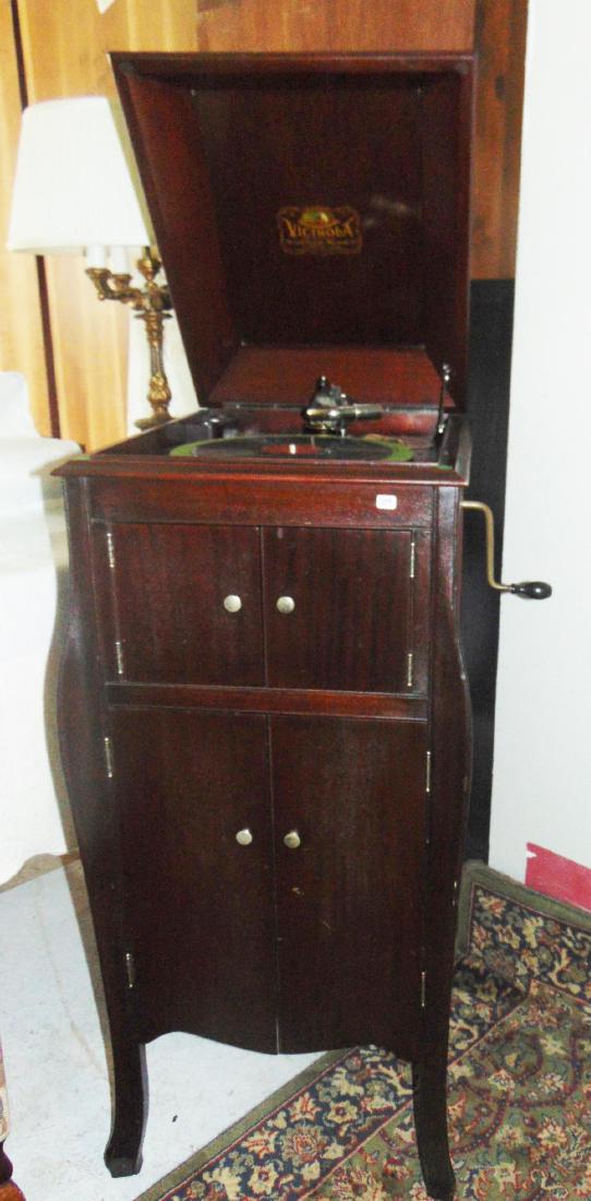 Victrola and Records: Victor Victrola serpentine mahogany case with a large amount of records (42" h x 18" w x 21" d).