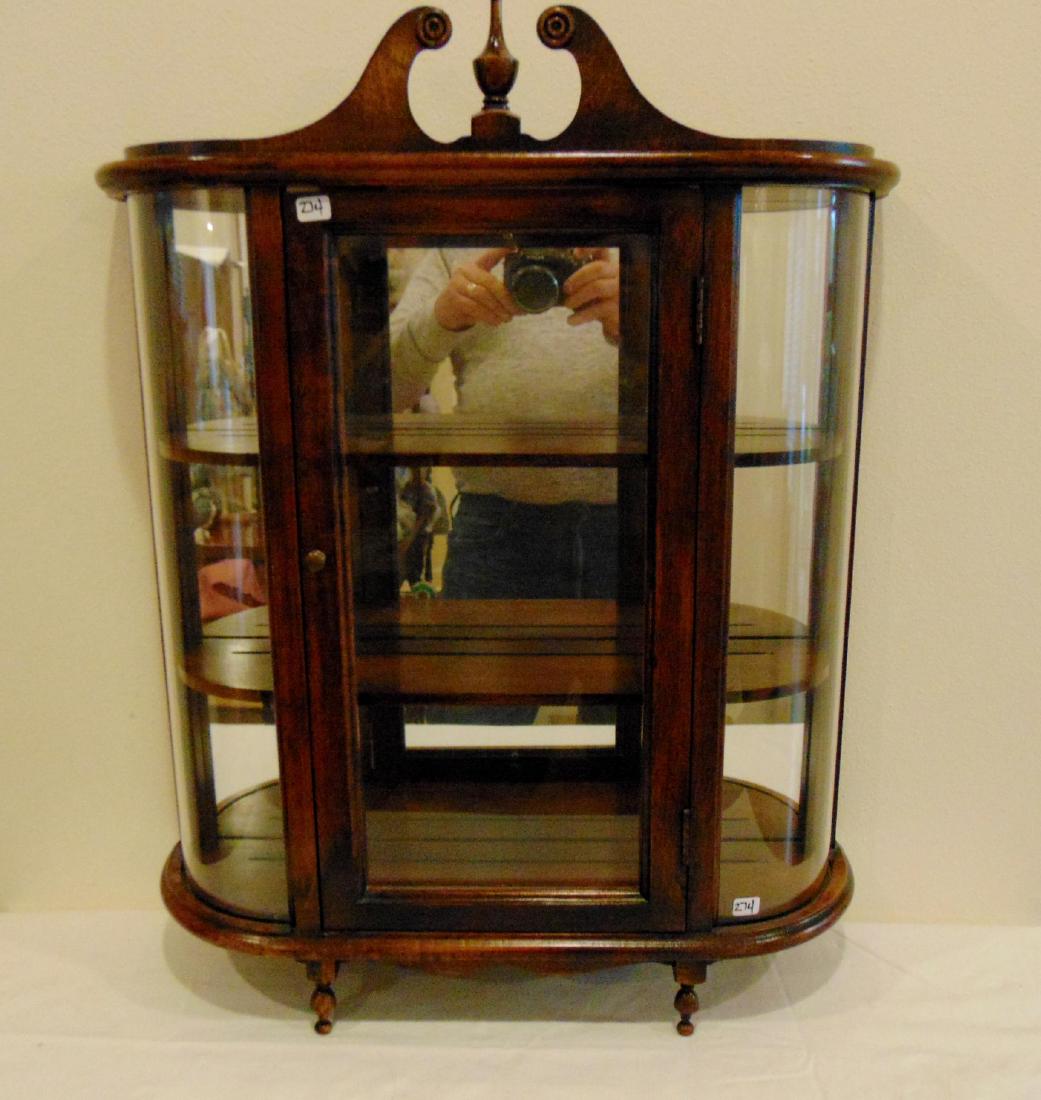 Wall Hung Curved Glass China Display Cabinet: Miniature wall hung curved glass china display cabinet with arched pediment and mirrored back. 22"w x 24"h x 6.5"d