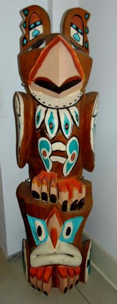 Totem Pole: Indian Totem from the North West Coast Haida Tribe. This Elaborate hand carved and hand painted totem measures 62"T.