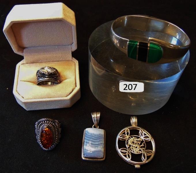 Sterling Silver Jewelry: Lot of Fancy Sterling Silver Jewely to include a Sterling Silver Malachite and Onyx Spring Cuff Bracelet, 2 Sterling Pendants, a Sterling Silver and Amber Ring, and a Open work Sterling Ring set with