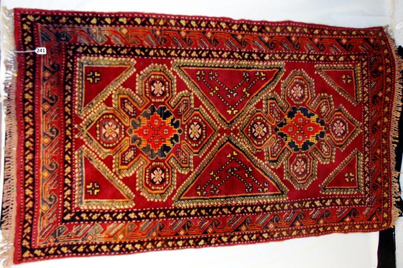 Persian Tribal Rug: Hand Tied Middle Eastern Persian Tribal Rug in Burgandy's, Creams, and Blues in a Geometric Floral pattern that still retains it's original edging and fringe. It measures 76"Lx48"W.