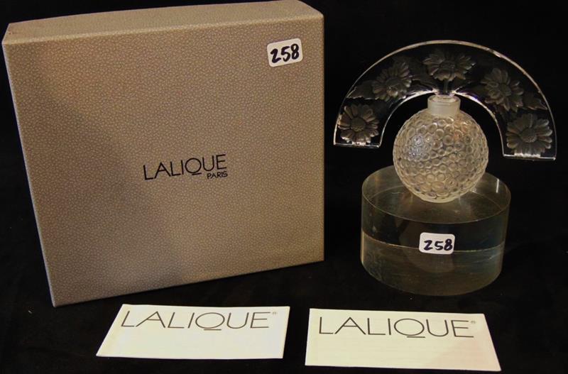 Lalique Stopper Perfume Bottle: Crystal Lalique Paris Folie Stopper Perfume Bottle and Original Box Style #1132700. This incredible Floral Motif Stopper and Scaled Bottom measures 3.5"Tx4"W.