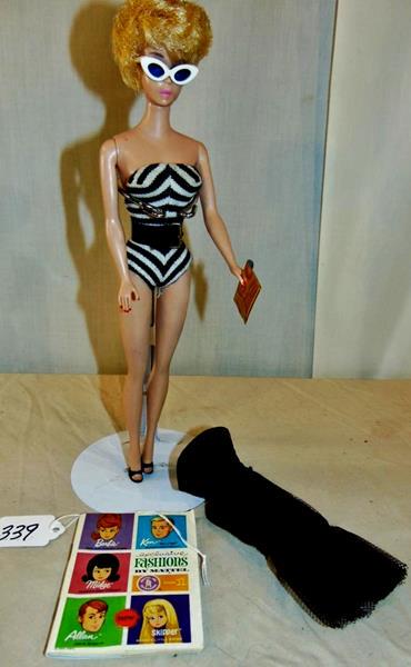 Extremely Early Mattel Barbie Doll: Extremely Early Barbie Doll by Mattel in striped bathing suit, sunglasses, black pumps, and a matching belt. Along with a black net fishtailed Evening Gown. Stamped on the buttocks 'Barbie, Pat. Pendi