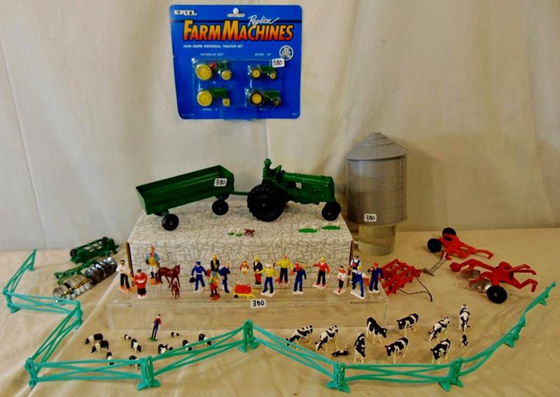 Group of Farm Toys: Group of Farm Toys to include Diecast Tractor and Farmer, Silo, Diecast Tractor attachments, Ertl Diecast John Deer, Historical Tractor set that is unopened, 9-piece platic fence, and miniature platic