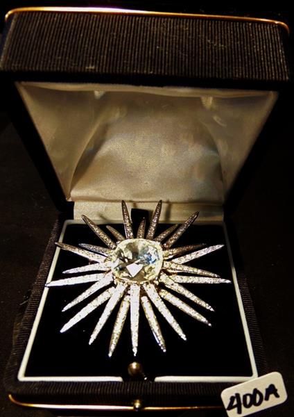 Kenneth Jay Lane Rhinestone Brooch: Kenneth Jay Lane Rhinestone Starburst Brooch covered in Rhinestones radiating out from a large center stone. This incredible Kenneth Jay Lane Rhinestone Brooch measures 2.5" Round and is in excellent 