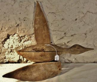 Early Hand Carved Wood Flying Duck Decoy: This unusual early hand carved wood flying duck decoy is in need of repair and in rough found condition: wing separation from body, splits in body, and no eyes. Age is uncertain. It measures 23"L.
