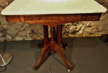Marble Top East Lake Table on Castors: This marble top Victorian press carved East Lake table on casters is in good overall condition, no chips or stains to marble top. It measures 30"Tx30"Wx20"D.