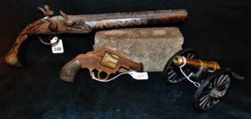 Group of Antique Weapons and more: Group to include Middle Eastern 18th Century pirate pistol with silver inlay and carled butt, a 1900's pistol found in the wall at a chalet on the lake in Mequon, WI., and toy cannon. The pirate pisto