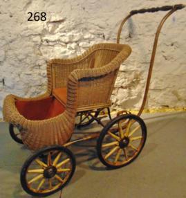 Kroll Brothers Wicker Youth Buggy 199-1910: This open top wicker youth buggy is in excellent original condition with oversized back wheels and wooden spokes and rims. It has a metal label that reads "Chicago Carriage Company, Kroll Brothers" on