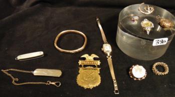Group of Quality Gold filled Jewelry: This group of quality gold filled jewelry include a Victorian locket, flor de lis pin, cameo pin depicting a person walking, hinged bracelet, and souvenir log rolling medal. Also included are a Lucien