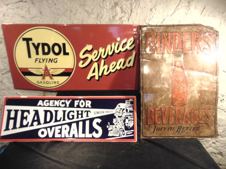Group of 3 Tin Advertisement Signs: This group contemporary of 3 tin advertising signs include a Binder's Beverages (30" x 20"), Headlight Overalls (12" x 36"), and Tydol Flying Gas (18" x 36"). Condition: used, Binders sign is bend bad