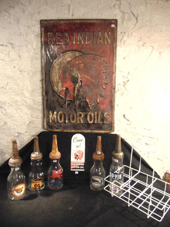 Contemporary Motor Oil Bottles and Tin Sign: This group of contemporary motor oil advertising collectibles include a Red Indian Tin Enamal Sign (29" x 20"), a Red Indian Push Plate (12" tall x 4" across) and 5 glass oil bottles with metal screw