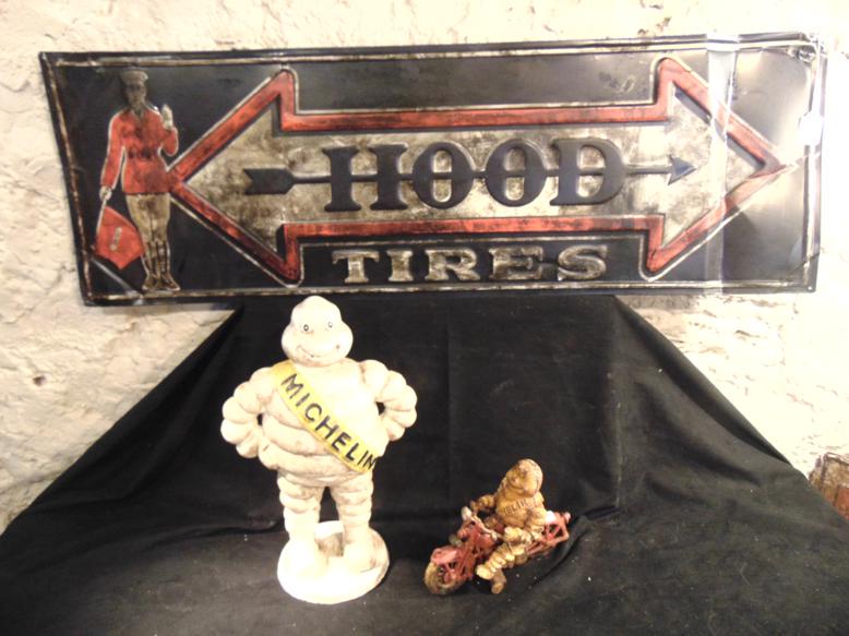 Group of Contemporary Tire Advertising Items to include: This gorup of contemporary tire advertising items include a cast iron 15" tall Michelin man Figure, a cast iron Michelin Man on a motobike (7" x 8") and a tin hood tire sign (14" x 42"). Condition: us