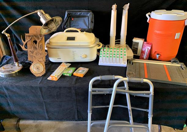Household and camping lot to include - walker, boot: Household and camping lot to include - walker, boot dryer, paper cutter, water cooler, lamp, pill organizer, cooler, clock and more