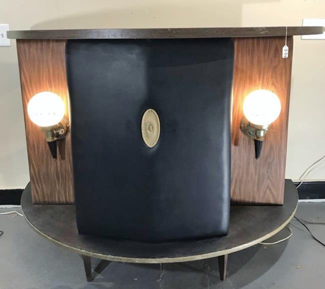 MCM Semi-Circular Electrified Bar: This 1960's MCM free standing light up bar has two electric glass globe on each side that read BAR, a padded vinyl front with a center medallion, semi circular top and shelves in the back. It measures