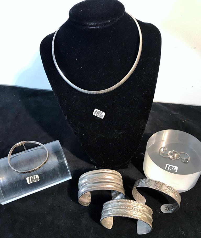 Group of Silver Includes Sterling Necklace/Bracelet: This group of silver include a sterling necklace and matching bracelet, 3 cuff bracelets to include a bracelet with arrows, stars and a swastika, and a 4 leaf clover sterling brooch.