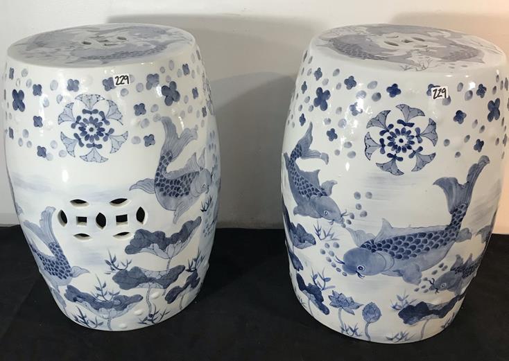 Pair of Chinese Blue and White Garden Stools Depicting: This pair of Chinese porcelain blue and white garden stools depicting koi have perforated designs, are in excellent condition and measure 19" tall x 15" across.