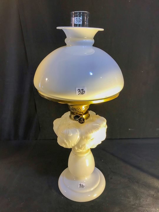 British Pre Civil War Mold Blown Floral Glass Oil Lamp: This British mold blown milk glass double burner oil lamp has a floral fount that depicts lillies, and a milk glass shade. In Excellent condition, it measures 22.5" tall X 10.5" across.