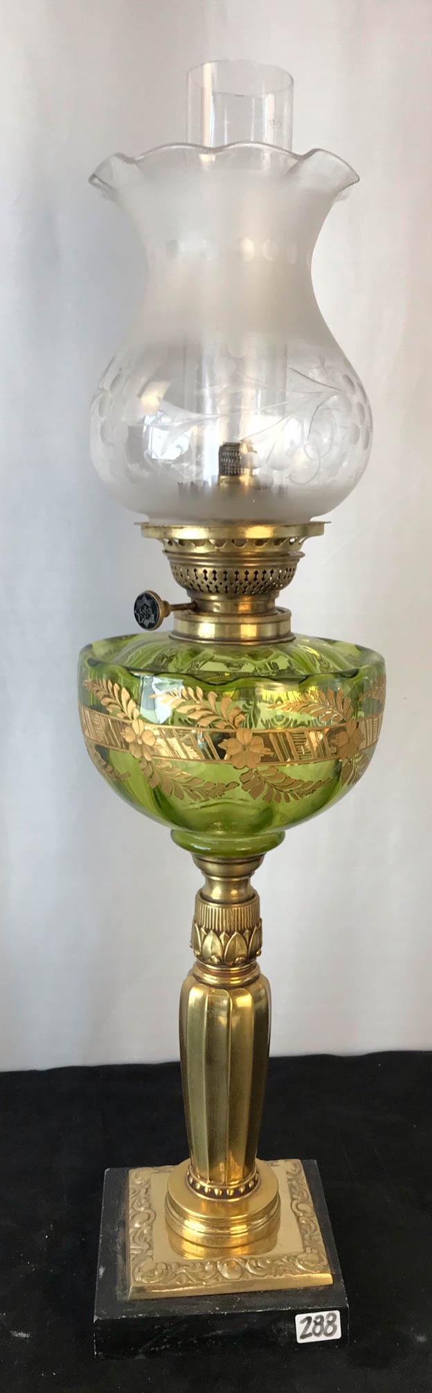 1860's Green Etched Glass Floral Baquet Lamp: This Civil War Era banquet lamp has a floral and gilded etched green fount, brass Egyptian Revival pedestal, carved Jett thumbwheel, and grape etched shade. it measures 24" tall X 6.5" across.