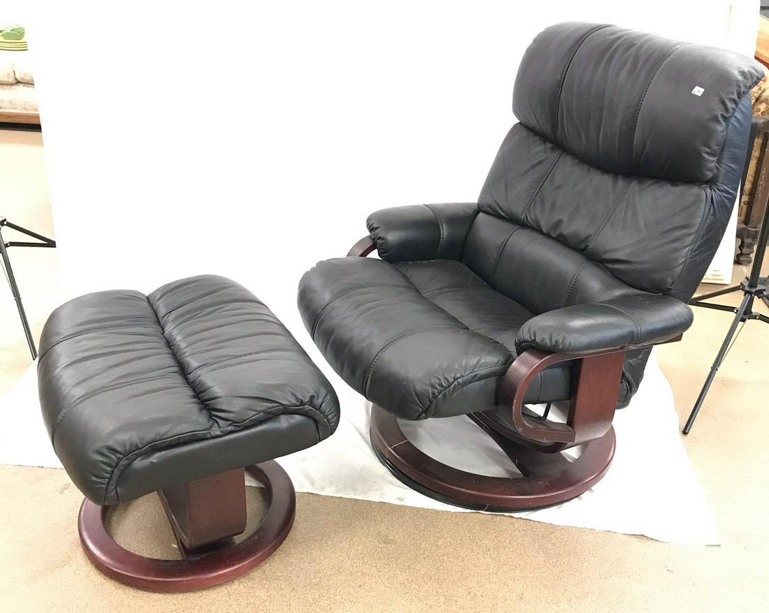 Contemporary Black Leather Reclining Chair and Ottoman: This contemporary black leather reclining armchair sits on a wood base and comes with a matching ottoman. It measures 40" tall X 33" across X 38" deep. Ottoman measures 17" tall X 24" wide X 20" deep.