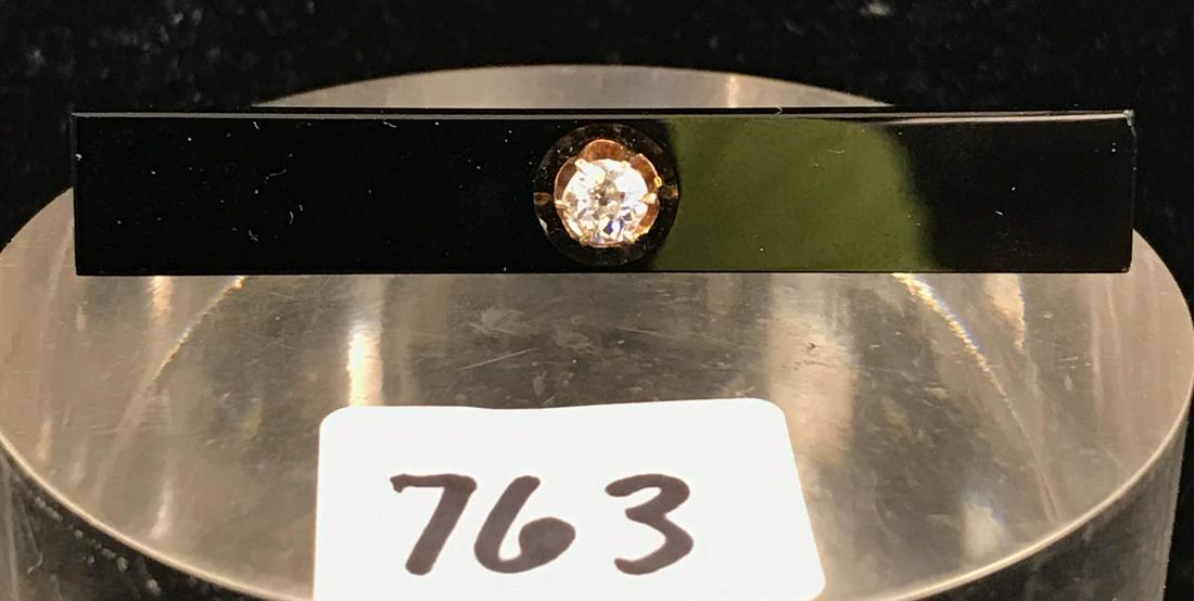 9K Yellow Gold Victorian Diamond and Onyx Bar Pin: This 9K yellow gold bar pin or brooch features a wide backdrop of black onyx, set in the middle with a single 30 to 40 point mine-cut genuine diamond. In excellent condition, the pin measures 2.25" lo