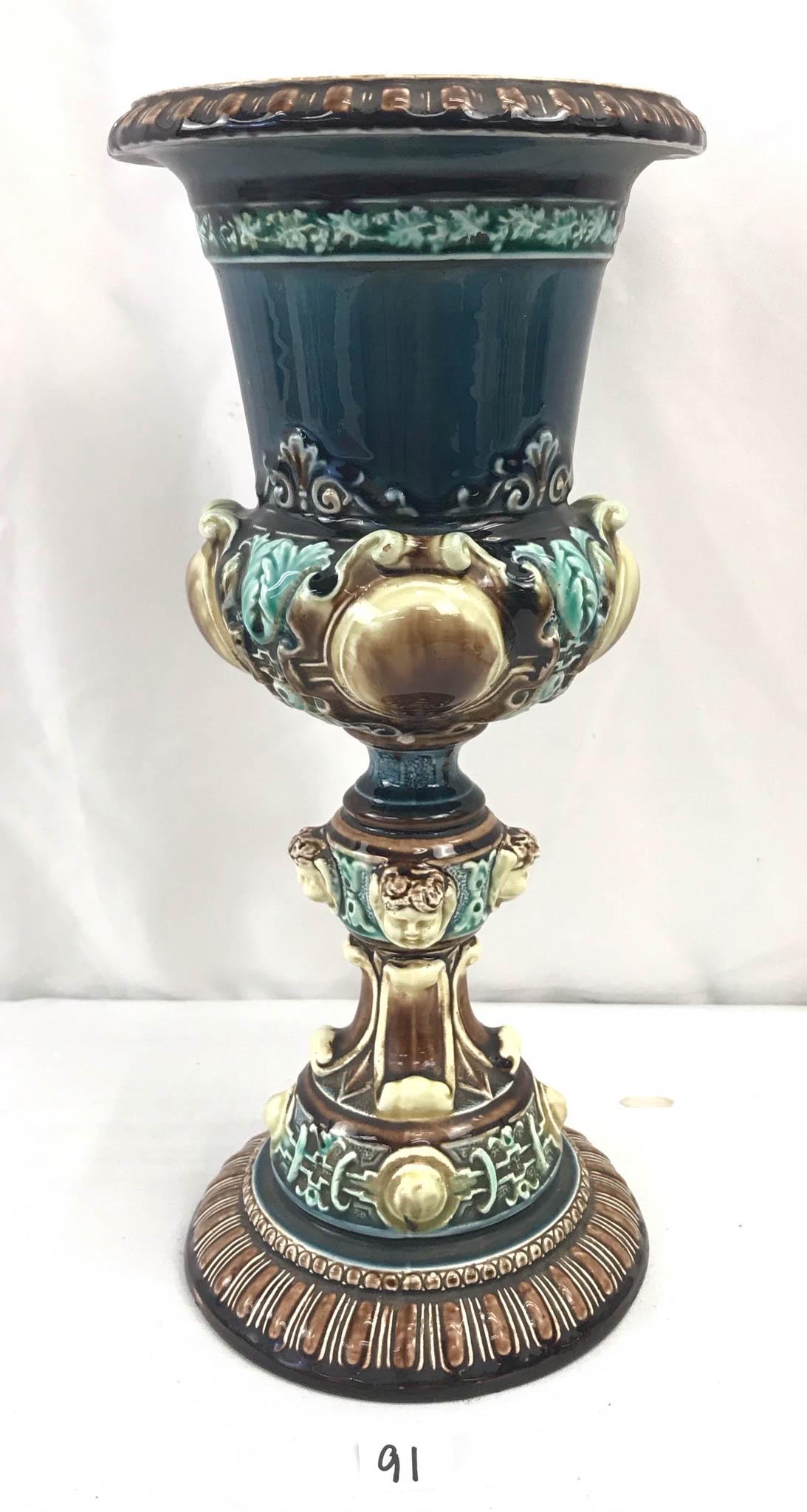 Rorstrand Swedish Majolica Urn dated 1872: This Majolica urn is signed by Rorstrand, the Swedish porcelain factory and hand dated 1872. It is in teals, greens and browns with cherub head decorations on the stem. In excellent condition, it meas