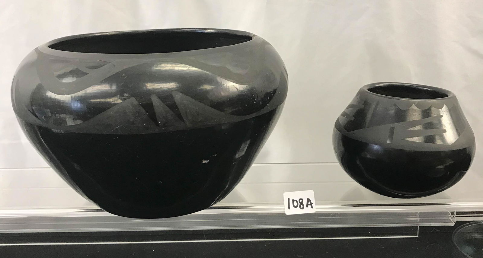 2 1930's Maria Martinez Signed Pots: These 2 signed by famous San Ildefonso Pueblo potter Maria Martinez (1887-1980). Famous for developing the black on black method of potting with her husband Julian in 1918. The larger pot is signed Ma