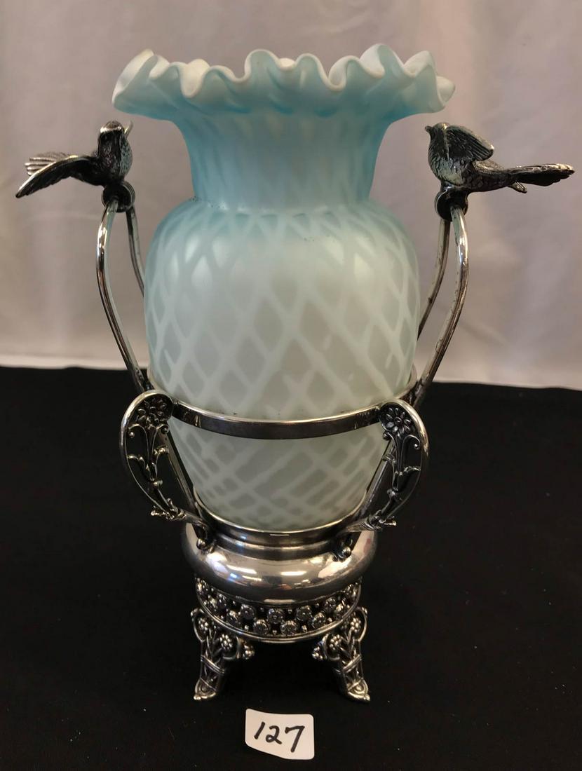 Victorian Iridescent Satin Glass Vase/ Holder: This late Victorian iridescent ruffled blue satin glass vase sits in a ornate silver plate holder from the Aurora Silver Plate Manufacturing Company. There are two spread wing birds on either side, 4 